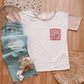 Boho style crochet pocket tee with colorblock pattern flatlay with light wash mom jeans 